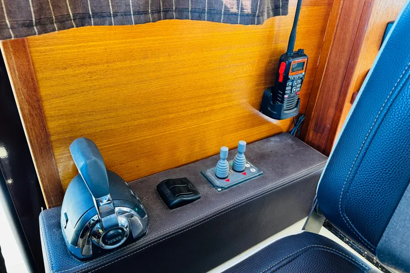 Slide: The Image of 2012 Ranger Tugs R-31 interior controls with radio and throttle levers. - 13