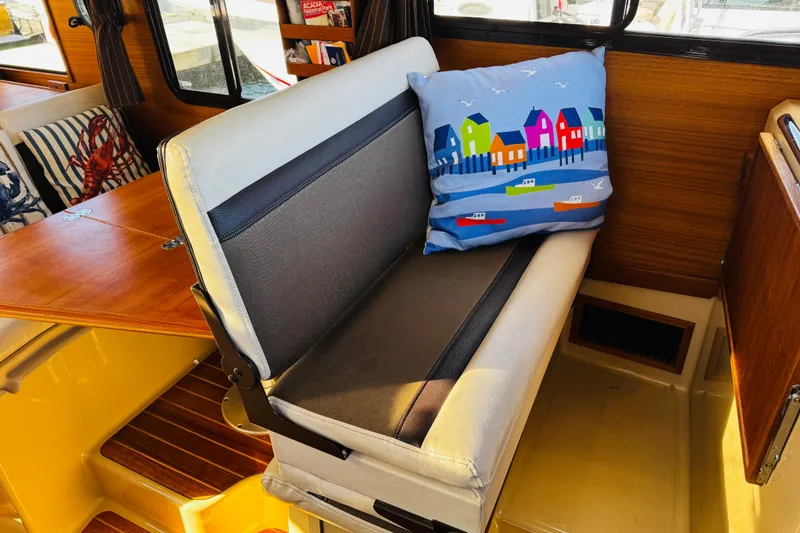 Slide: The Image of Interior of 2012 Ranger Tugs R-31 with colorful cushion and wooden accents. - 15