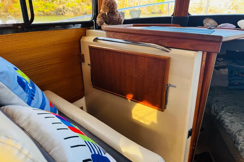 Slide: The Image of Interior of 2012 Ranger Tugs R-31 with wooden accents and colorful cushions. - 16