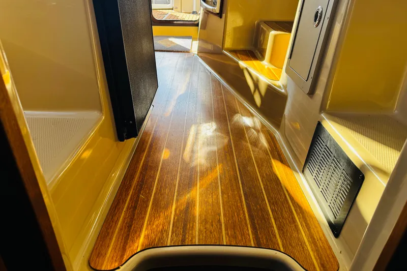 Slide: The Image of Interior view of 2012 Ranger Tugs R-31 with polished wooden flooring. - 20