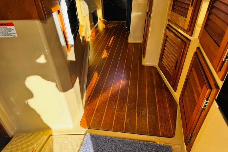 Slide: The Image of Interior of 2012 Ranger Tugs R-31 with wooden flooring and cabinets. - 21