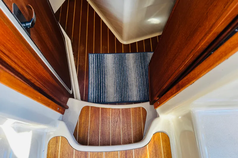 Slide: The Image of Interior view of 2012 Ranger Tugs R-31 with wooden flooring and striped rug. - 24