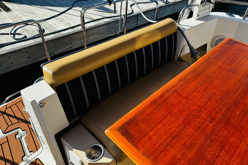 Slide: The Image of 2012 Ranger Tugs R-31 boat interior with wooden table and cushioned seating. - 31
