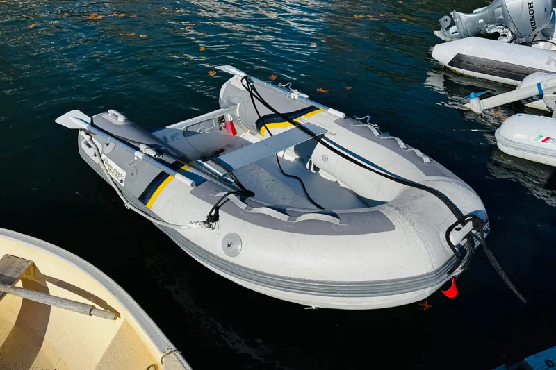 Slide: The Image of Inflatable dinghy docked on water, associated with 2012 Ranger Tugs R-31 model. - 33