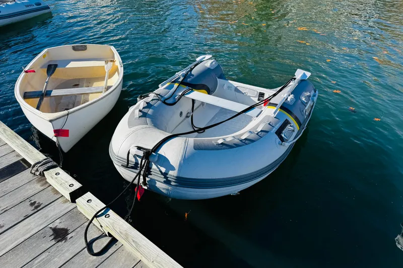 Slide: The Image of Two small boats docked on calm water near a wooden pier. - 34