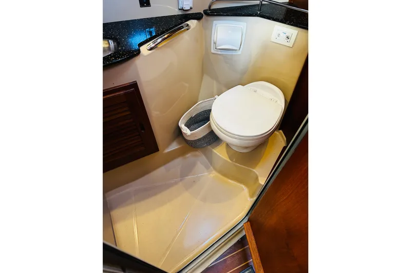 Slide: The Image of 2012 Ranger Tugs R-31 boat bathroom with toilet and sink, compact and efficient design. - 6