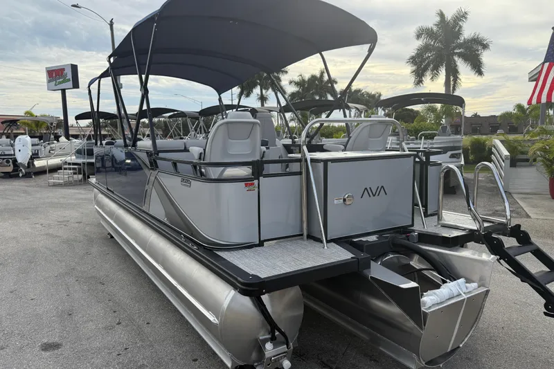 Slide: The Image of 2026 Avalon 2385 LSZ Rear Fish Tri Toon boat with canopy, parked outdoors. - 10