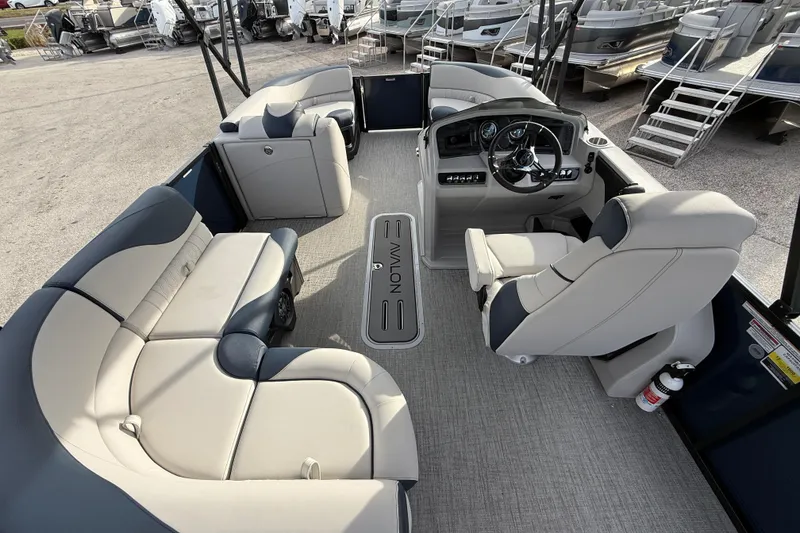 Slide: The Image of 2026 Avalon 2385 LSZ Tri Toon boat interior with plush seating and modern helm. - 17