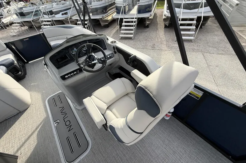 Slide: The Image of 2026 Avalon 2385 LSZ Rear Fish Tri Toon boat interior with steering console and seating. - 28