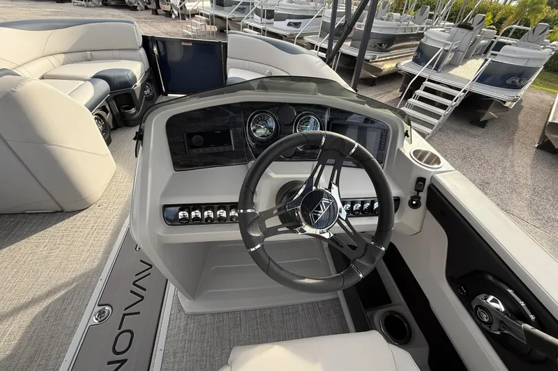 Slide: The Image of 2026 Avalon 2385 LSZ Rear Fish boat dashboard with steering wheel and controls. - 29