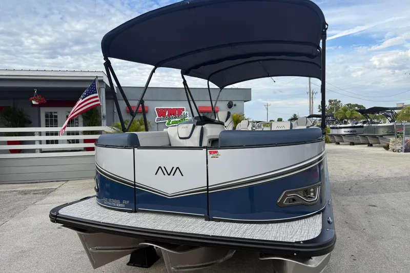Slide: The Image of 2026 Avalon 2385 LSZ Rear Fish Tri Toon boat with canopy, parked at dealership. - 3