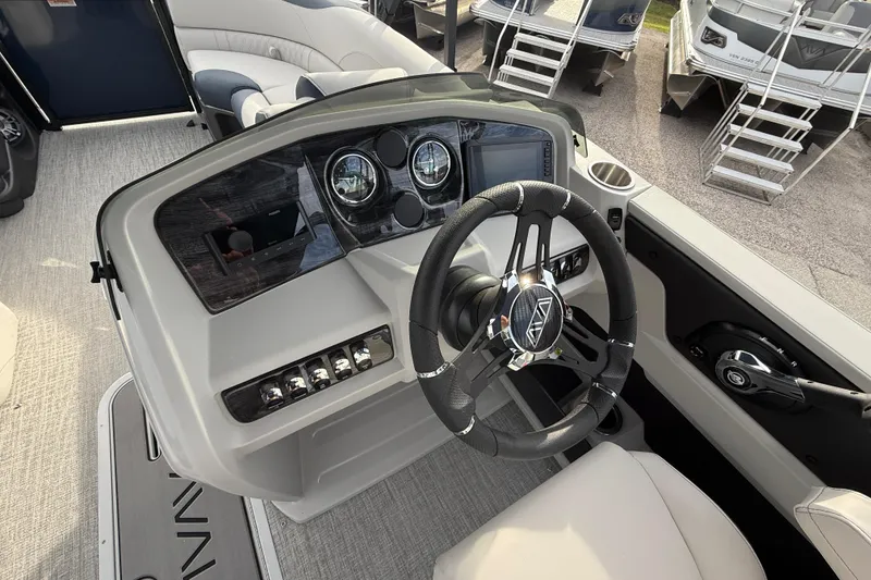 Slide: The Image of 2026 Avalon 2385 LSZ Rear Fish boat dashboard with steering wheel and controls. - 30
