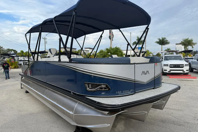 Slide: The Image of 2026 Avalon 2385 LSZ Rear Fish Tri Toon boat with canopy, parked outdoors. - 6