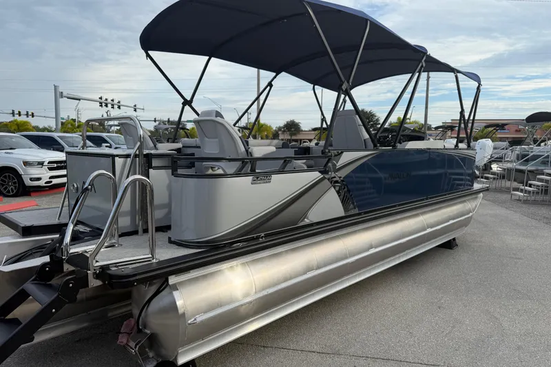 Slide: The Image of 2026 Avalon 2385 LSZ Rear Fish Tri Toon boat with canopy, parked outdoors. - 7