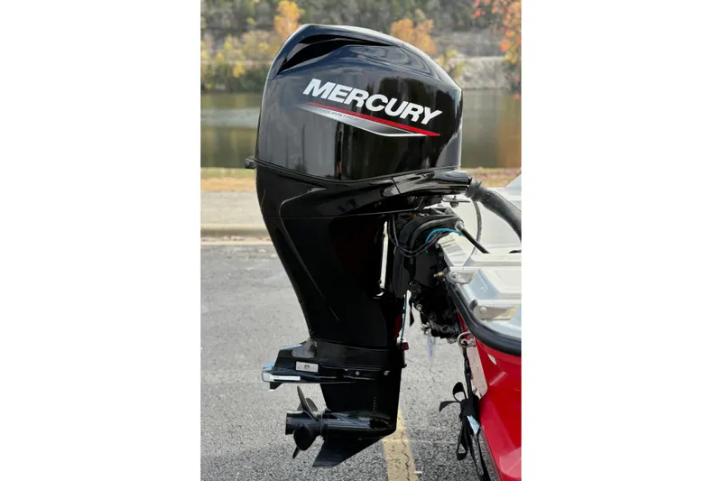 Slide: The Image of 2022 Bayliner Element M15 with Mercury outboard motor, parked near a scenic lake. - 10