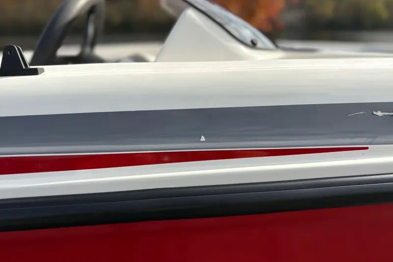 Slide: The Image of 2022 Bayliner Element M15 boat side view with red and gray detailing. - 17