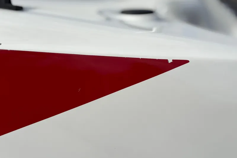 Slide: The Image of Close-up of 2022 Bayliner Element M15 boat with red and white design. - 19