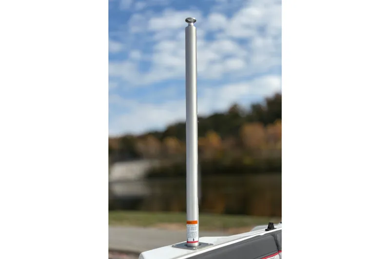 Slide: The Image of 2022 Bayliner Element M15 boat with a silver pole against a blurred natural background. - 22