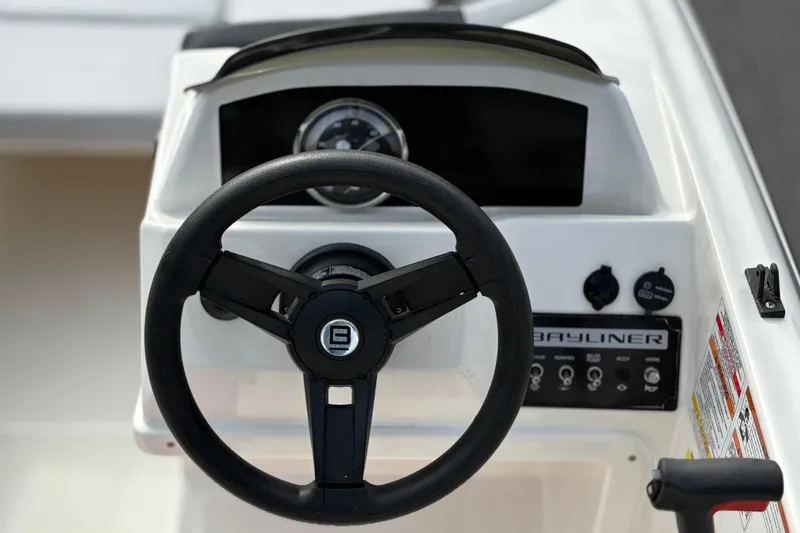 Slide: The Image of Steering wheel and dashboard of 2022 Bayliner Element M15 boat. - 23