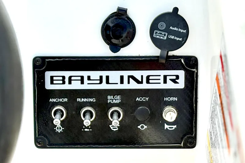 Slide: The Image of Control panel of 2022 Bayliner Element M15 boat with switches and audio input. - 24