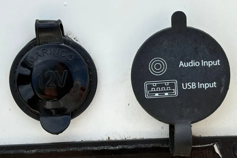 Slide: The Image of 12V and USB audio inputs on 2022 Bayliner Element M15 boat. - 26