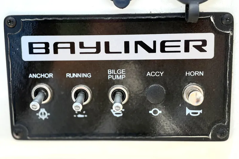 Slide: The Image of 2022 Bayliner Element M15 control panel with switches for anchor, running, bilge pump, and horn. - 27
