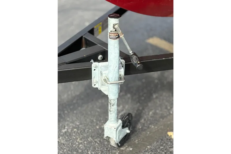 Slide: The Image of Trailer jack for 2022 Bayliner Element M15 boat on asphalt surface. - 39