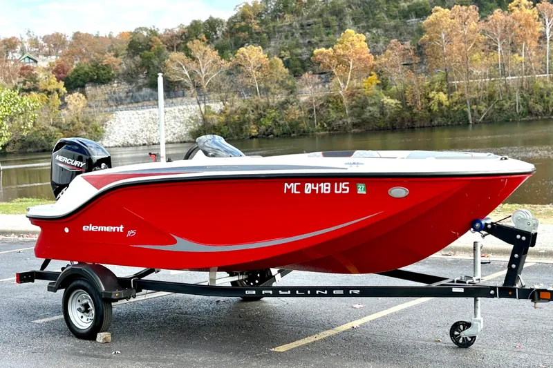 Slide: The Image of 2022 Bayliner Element M15 boat on trailer by a scenic river. - 4