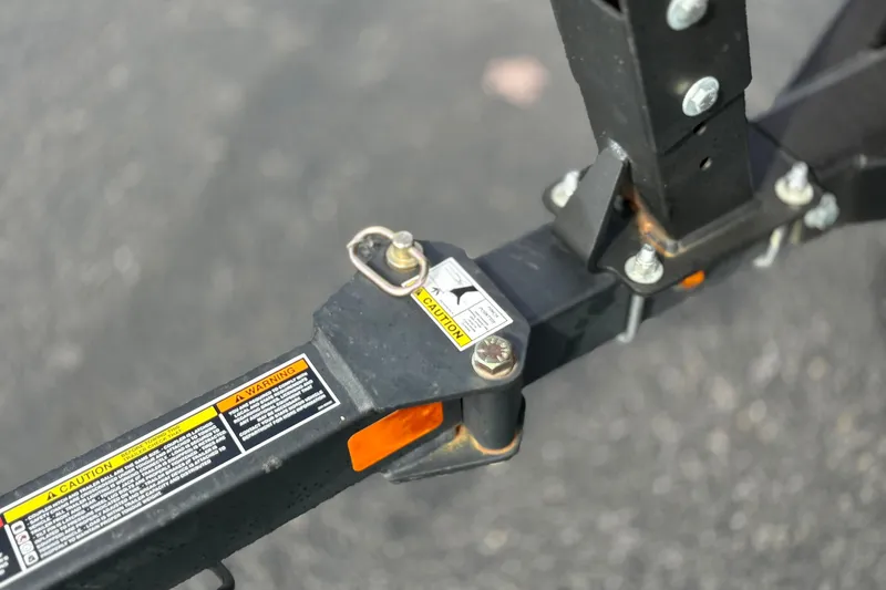 Slide: The Image of Trailer hitch of 2022 Bayliner Element M15 with caution labels and bolts. - 41