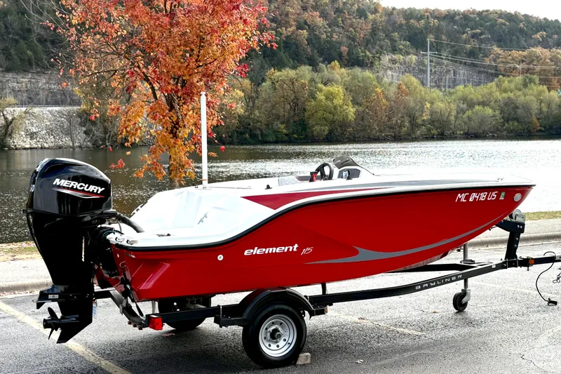 Slide: The Image of 2022 Bayliner Element M15 boat on trailer by scenic lake with autumn trees. - 5