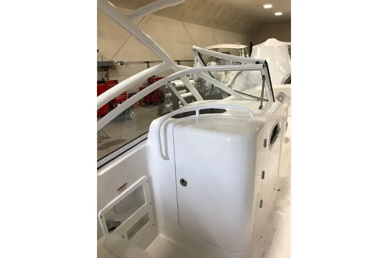 Slide: The Image of 2018 Edgewater 248CX Crossover boat interior with sleek white design. - 6