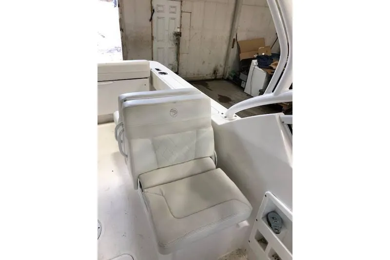 Slide: The Image of 2018 Edgewater 248CX Crossover boat seat in a garage setting. - 8