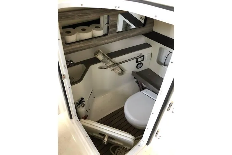 Slide: The Image of 2018 Edgewater 248CX Crossover boat interior with compact bathroom amenities. - 9