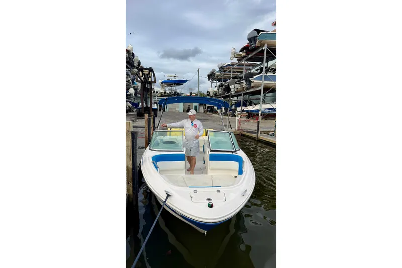 Slide: The Image of 2018 Chaparral 21 H2O Sport boat interior with steering wheel and seating. - 1