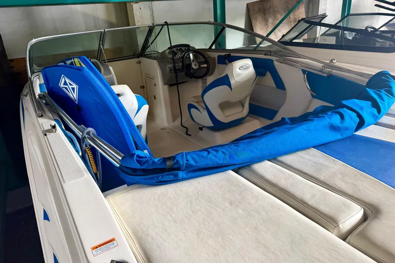 Slide: The Image of 2018 Chaparral 21 H2O Sport boat interior with blue and white seating. - 4