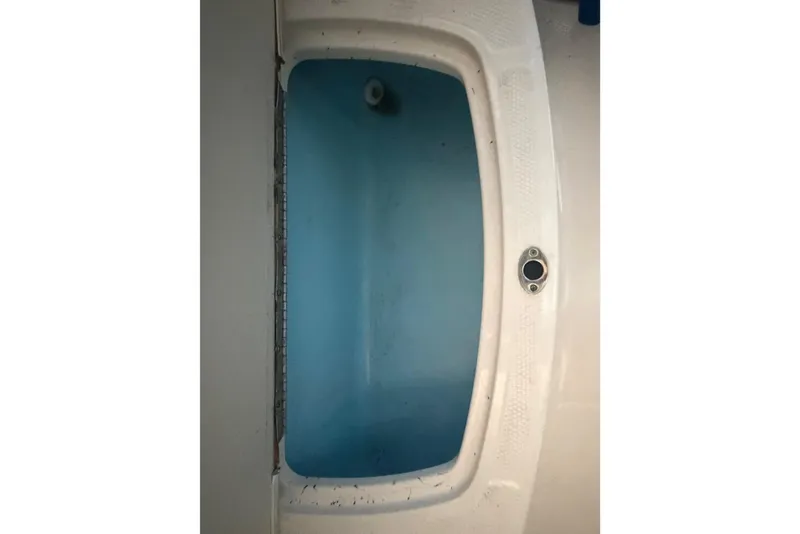 Slide: The Image of 2018 Chaparral 21 H2O Sport boat interior, featuring a blue and white design. - 6