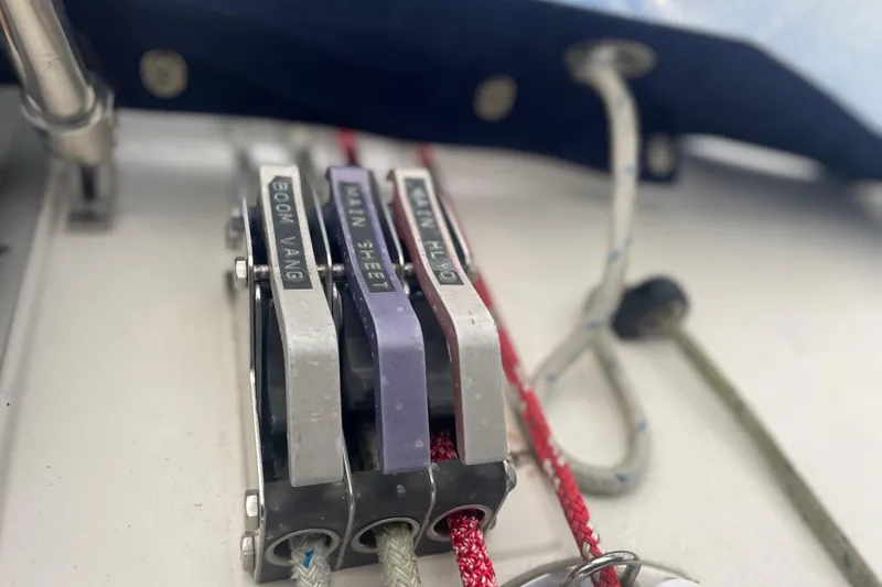 Slide: The Image of Close-up of sailing rope clutches labeled "Boom Vang" and "Main Sheet" on a 1989 Hunter 35.5. - 10