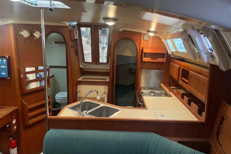 Slide: The Image of Interior of 1989 Hunter 35.5 sailboat with kitchen, sink, and wooden cabinetry. - 16