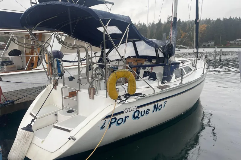Slide: The Image of 1989 Hunter 35.5 sailboat named "¿Por Que No?" docked in a marina. - 2