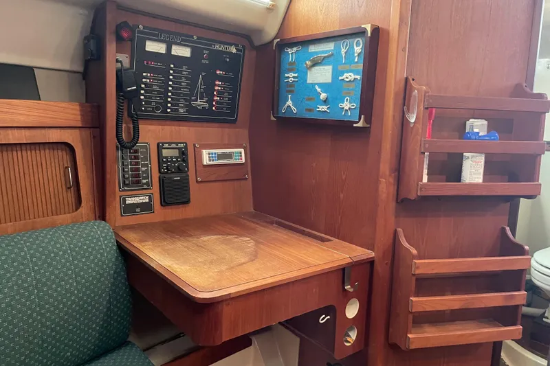 Slide: The Image of 1989 Hunter 35.5 yacht interior with navigation station and control panel. - 23