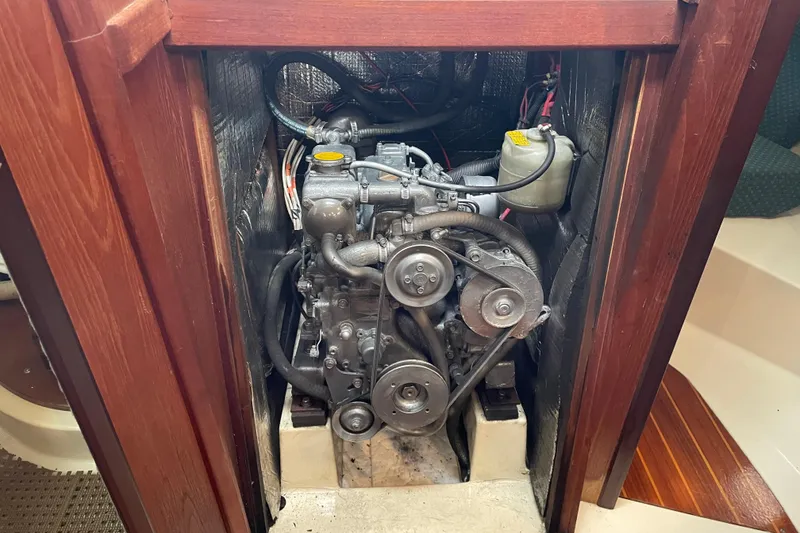 Slide: The Image of Engine compartment of a 1989 Hunter 35.5 sailboat, showcasing mechanical components. - 24