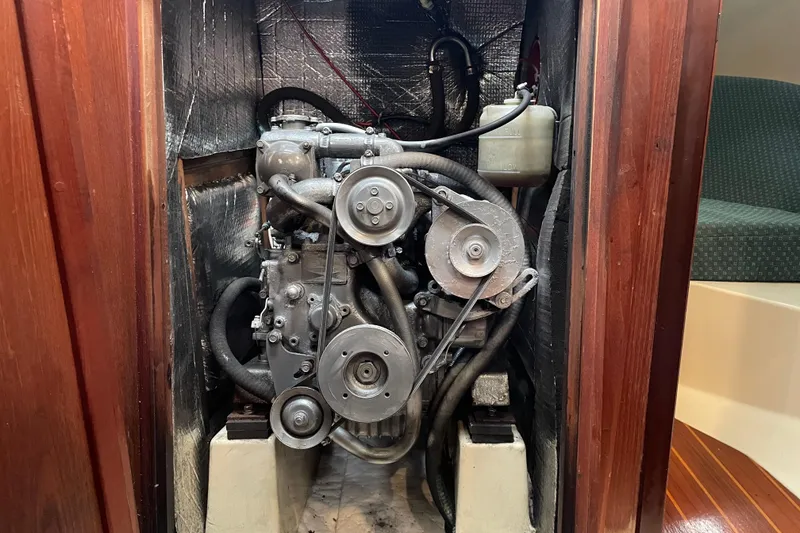 Slide: The Image of Engine compartment of a 1989 Hunter 35.5 sailboat, showcasing mechanical components. - 25