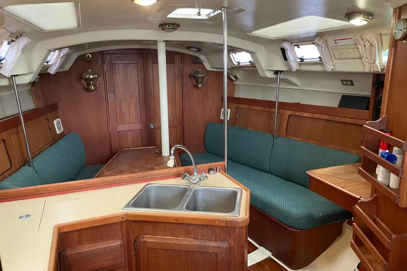 Slide: The Image of Interior of 1989 Hunter 35.5 sailboat with wood finish and green seating. - 28