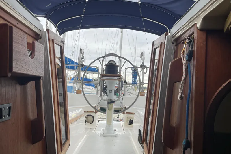 Slide: The Image of Interior view of 1989 Hunter 35.5 sailboat cockpit with wooden details and steering wheel. - 6