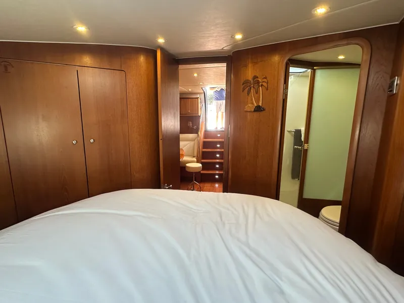 Slide: The Image of Luxurious 2006 Tiara Yachts Sovran interior with wood paneling and cozy bedroom. - 10