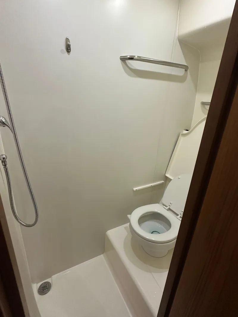 Slide: The Image of Compact bathroom in 2006 Tiara Yachts Sovran, featuring shower and toilet. - 12