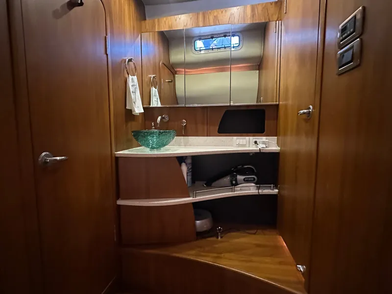 Slide: The Image of Luxurious 2006 Tiara Yachts Sovran bathroom with elegant wood finish and modern glass sink. - 13