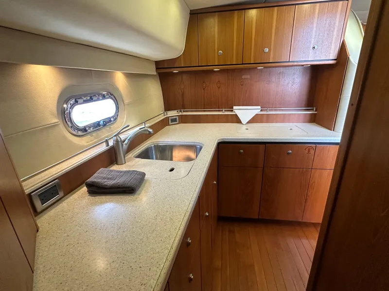 Slide: The Image of 2006 Tiara Yachts Sovran kitchen with wood cabinets and modern sink. - 15