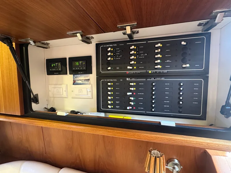 Slide: The Image of Electrical control panel inside 2006 Tiara Yachts Sovran, featuring switches and digital displays. - 18