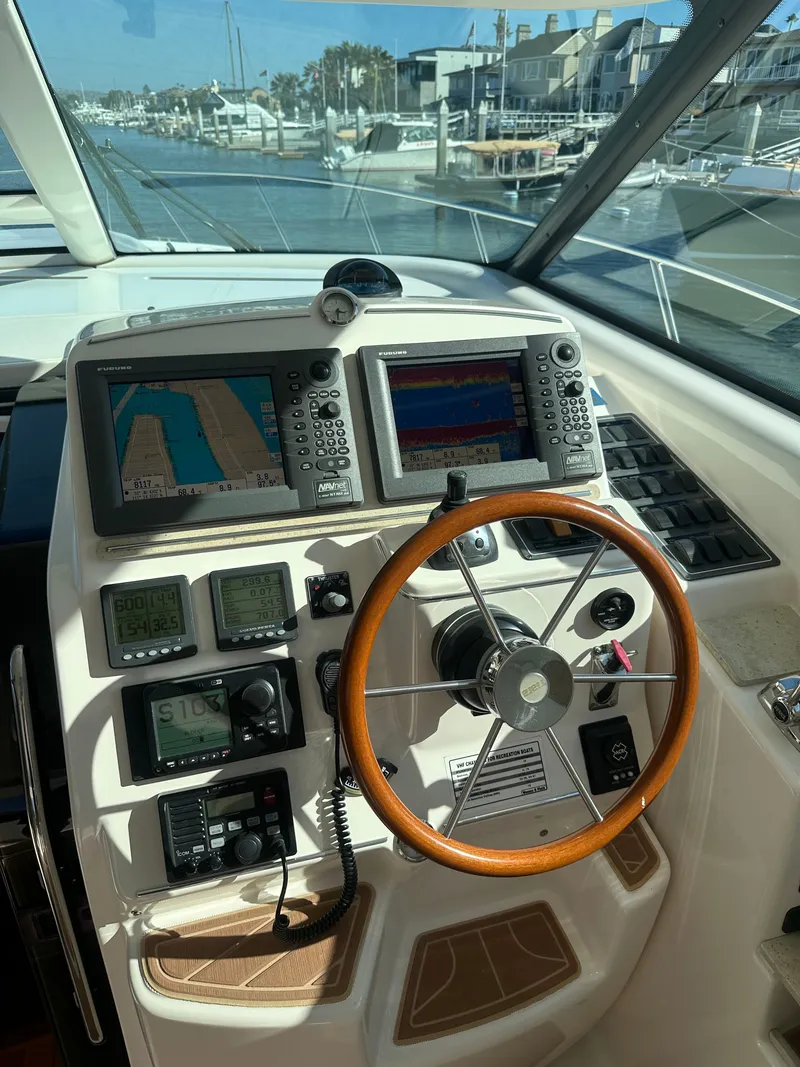 Slide: The Image of 2006 Tiara Yachts Sovran helm with navigation equipment and wooden steering wheel. - 22